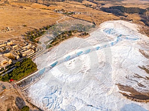 Natural travertine pools blue water in Pamukkale Turkey aerial top view