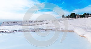 Natural travertine pools pool blue water and terraces in Pamukkale Turkey