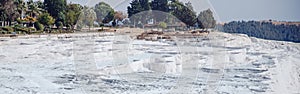 Natural travertine pools pool without water drought and terraces in Pamukkale Turkey