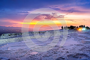 Natural travertine pools and terraces at sunset in Pamukkale, Turkey.