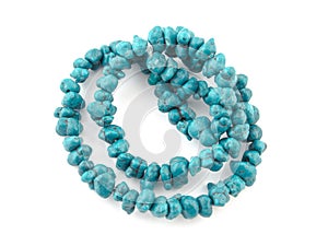 Natural turquoise beads on a white background