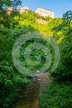 Natural Tuscan landscape with a river in the wood, at early morning in June 2019, Italy