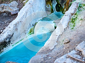 Natural underground mineral river and public bathtubs of cascade