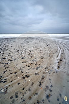 Natural view of the beach in Bjerregard, Denmark under a cloudy sky