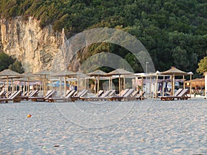 Natural view beach lounges at a sandy shore in summertime