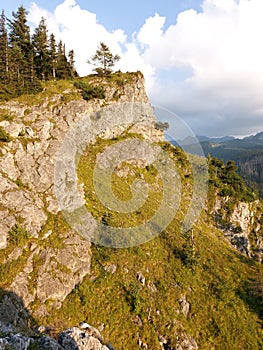 Natural view of rocky mountains and forest under a cloudy sky