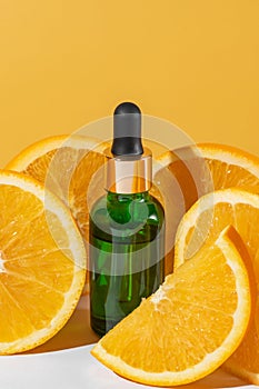 Natural vitamin c serum, skincare, essential oil products. Cosmetic green glass dropper and fresh juicy orange fruit