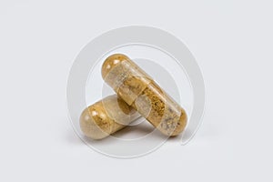 Natural vitamins in capsules on a white background