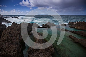 Natural volcanic pools of Porto Moniz during storm