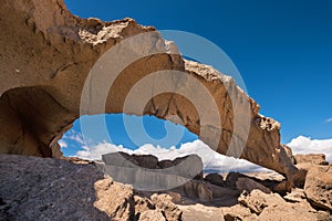 Natural volcanic rock arch formation in desertic landscape in Tenerife, Canary islands, Spain. photo