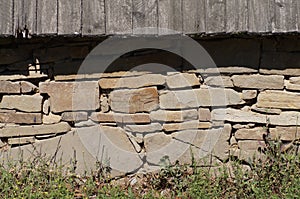 A natural wall, made of stone taken out of the river and a canopy made of natural wood.