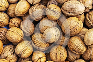 Natural walnut background pattern texture Abstract walnuts heap pattern background Blurred edges frame Natural food in-shell nuts