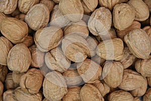 Natural walnut background pattern texture Abstract walnuts heap pattern background Blurred edges frame Natural food in-shell nuts