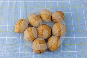 Natural walnuts pile pattern, background blurred edges frame, food in shell nuts walnuts
