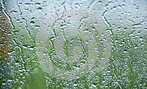 Natural water drop background.CAR Window glass with condensation of natural water drops .Abstract photo