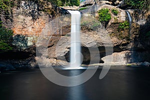 Natural waterfall with flowing water of rock cliff