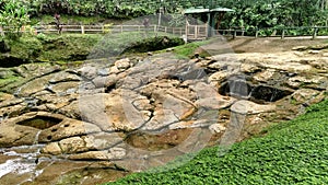 Natural waterfont with ancient petroglyphs knowed as `fuente de lavapatas` at Colombian San Agustin archaeological park.