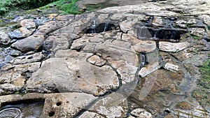 Natural waterfont with ancient petroglyphs knowed as `fuente de lavapatas` at Colombian San Agustin archaeological park.