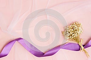Natural white flowers with ribbon over thew white background.