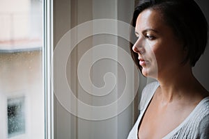 Natural woman looking out the window