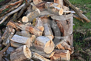 Natural wood background - closeup of chopped firewood. Firewood stacked and prepared for winter. A pile of firewood by the road