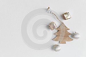 Natural wood craft Christmas with golden gift box and silver white ball on cement wall greeting minimalism background