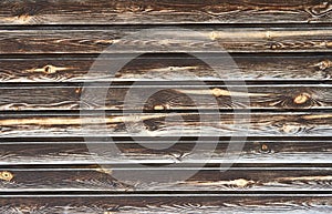 Natural wooden background with knots. Dark wood texture. Copy space for text. Close-up