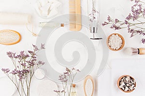 Natural wooden beige accessories and cosmetics for bathroom - cream, sponge, towel, scrub, soap, gel dispenser, brush and lavender