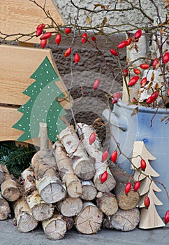Natural wooden christmas decoration with red rosehips.