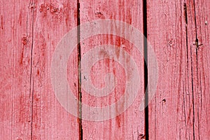 Natural wooden painted red boards, wall or fence with knots. Abstract textured background, empty template. Painted wooden planks