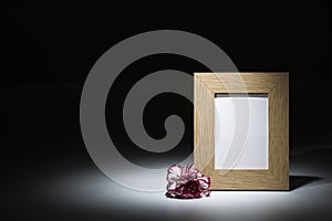 Natural wooden picture frame with carnation