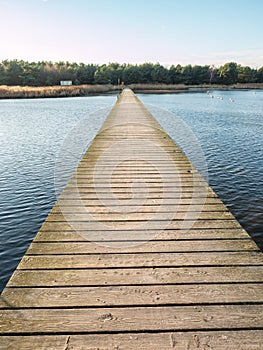 Natural and wooden walk pier over water