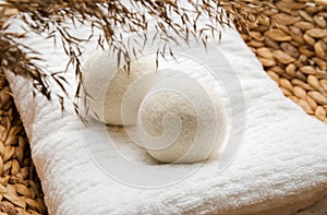 Natural wool dryer balls for more soft clothes while tumble drying in washing machine concept. photo