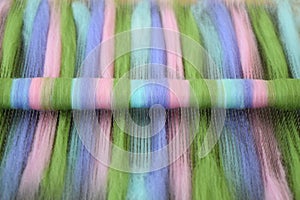 Natural wool fiber rolag on a blending board