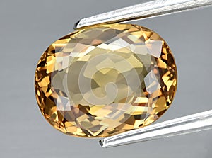 natural yellow beryl heliodor gem on the background