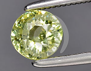 natural yellow green grossular garnet gem on the background