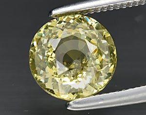 natural yellow grossular garnet gem on the background