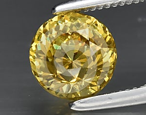 natural yellow grossular garnet gem on the background