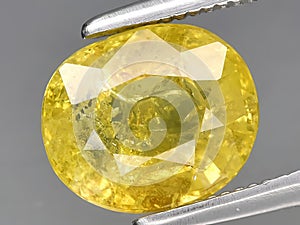 natural yellow grossular garnet gemstone on the background
