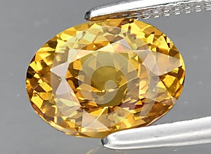 natural yellow grossular gem on the background