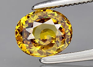 natural yellow grossular gem on the background