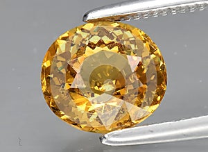 natural yellow grossular gem on the background