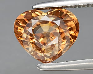 natural yellow zircon gem on the background photo