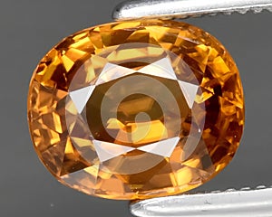 natural yellow zircon gem on the background
