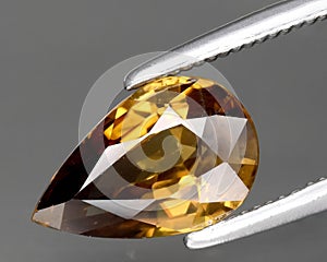 natural yellow zircon gem on the background