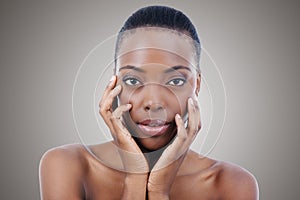 Naturally alluring. Studio shot of a beautiful african american model isolated on gray.