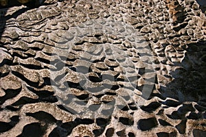 Naturally eroded rock with fist scale texture photo