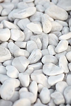 Naturally polished white rock pebbles background. white stones