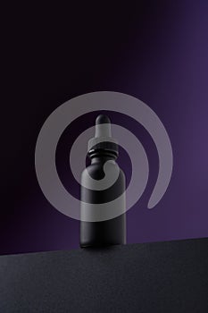 Naturally radiant: Facial serum on a dark purple background. Concept of natural care