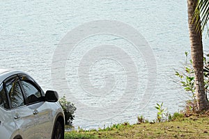 Nature background, Beautiful scenery and white car parked at the beach with sea background.